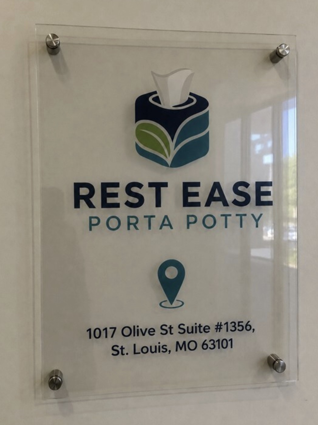 Rest Ease Porta Potty office signage with address at 1017 Olive St Suite 1356, St. Louis, MO 63101